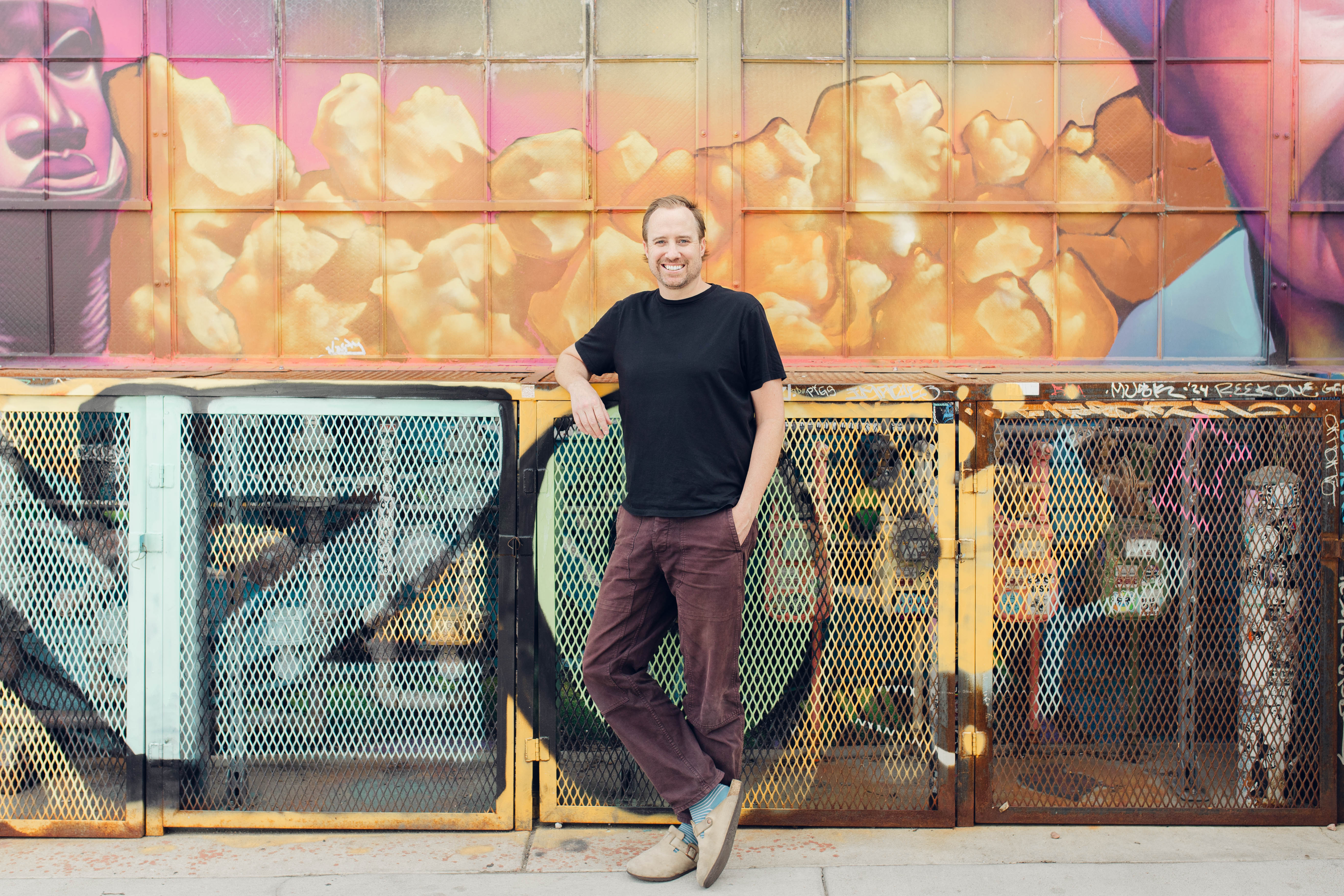 Family sitting around a fire pit in front of cabin