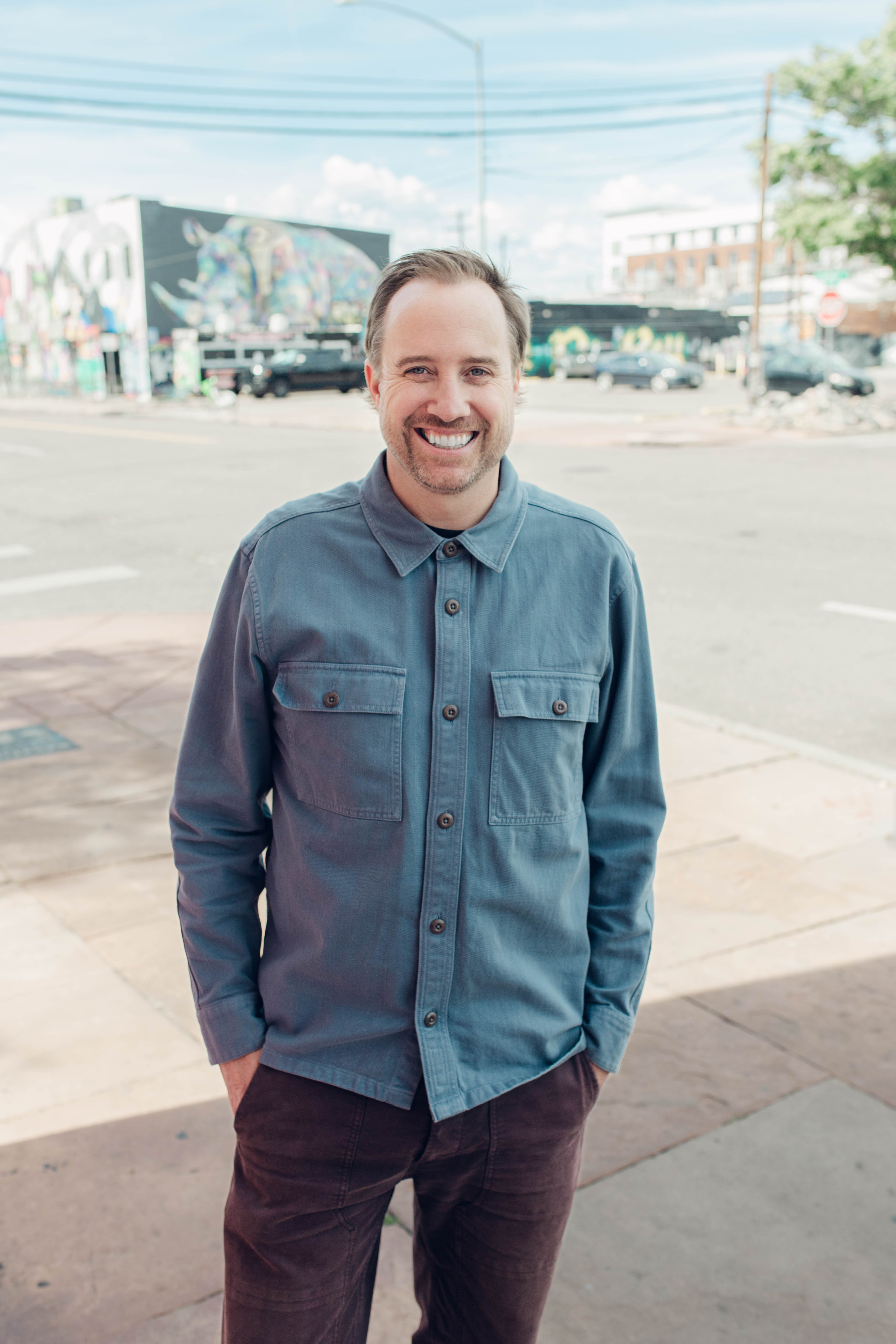 Family sitting around a fire pit in front of cabin