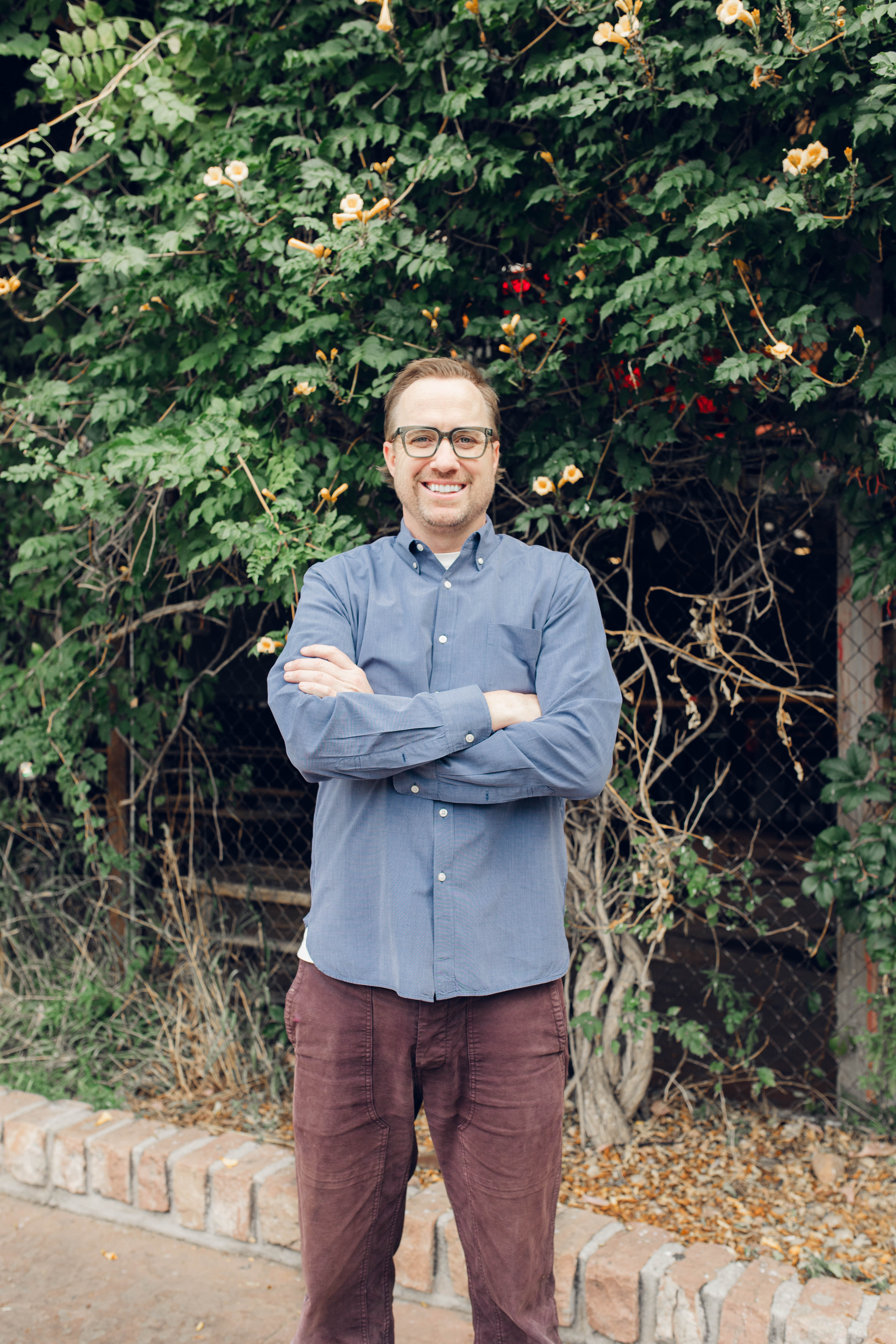 Family sitting around a fire pit in front of cabin